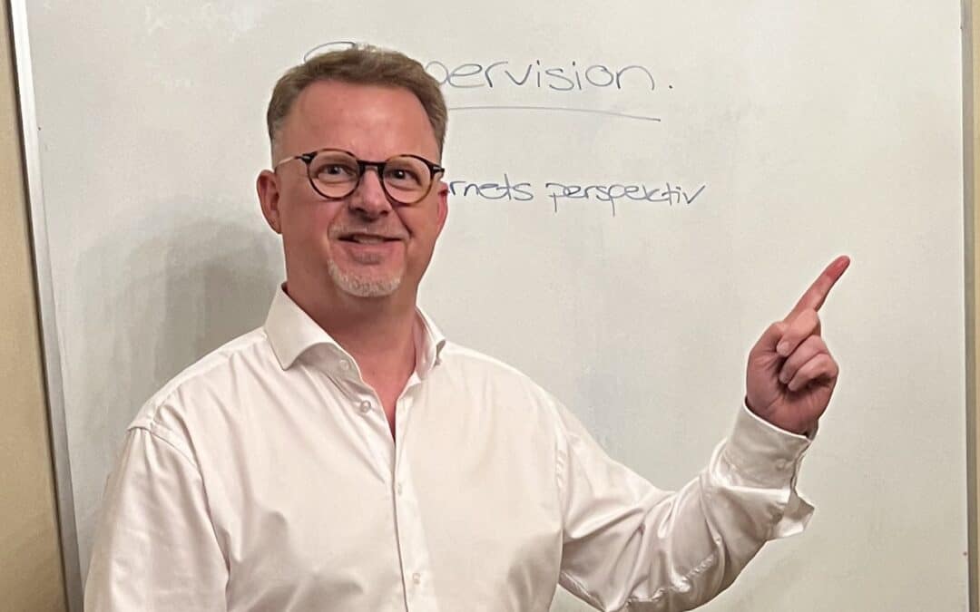 Thomas Lumholt peger på en whiteboard om supervision og barnets perspektiv i kommunal rådgivning.